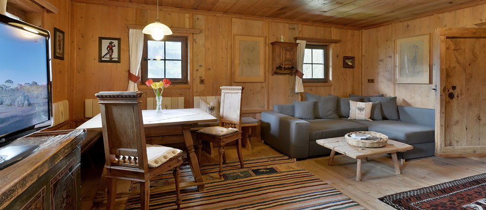 living room with dining table and cosy sofa bed